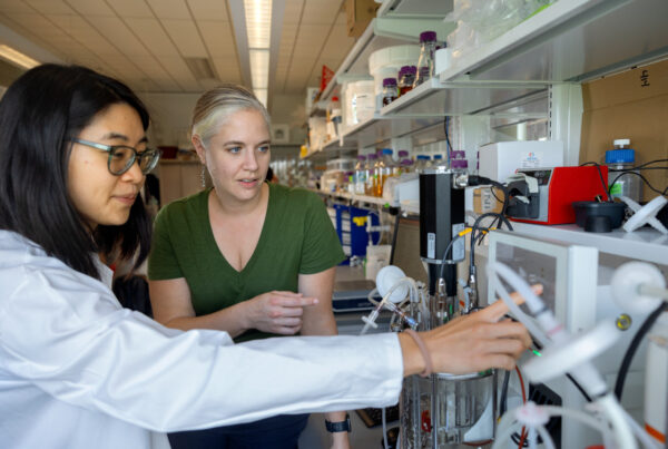 Two women in a lab discuss a technology
