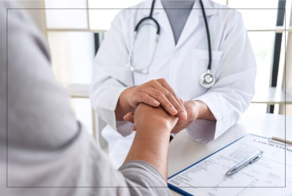 Image of doctor holding patients hand